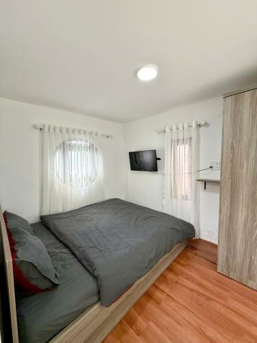 a bedroom with a large bed in a room at RoBin's Home in Da Thanh