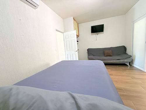 a room with a bed and a couch at Private jacuzzi pool 2 level house private coto in Mezcales