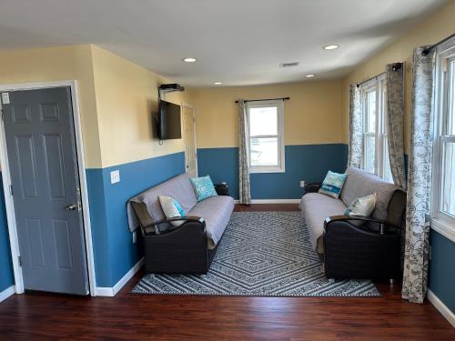 a living room with two couches and a rug at JD Apartment and House in Seaside Heights