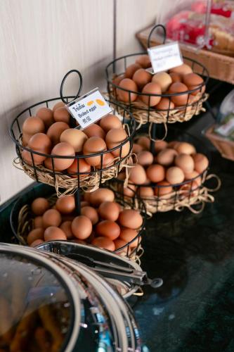 two baskets of eggs sitting on a table at วัน บัดเจท เชียงราย บ้านใหม่ in Chiang Rai