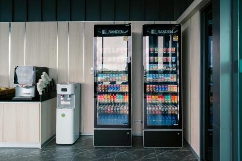 two soda vending machines in a store with drinks at วัน บัดเจท เชียงราย บ้านใหม่ in Chiang Rai