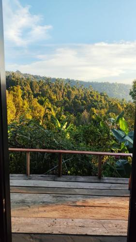 a balcony with a view of a forest at Munduk Nature Lodge in Munduk