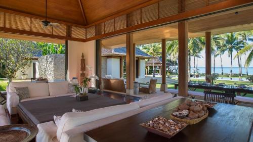a living room with a couch and a table at Jivana Beach Villas in Natai Beach