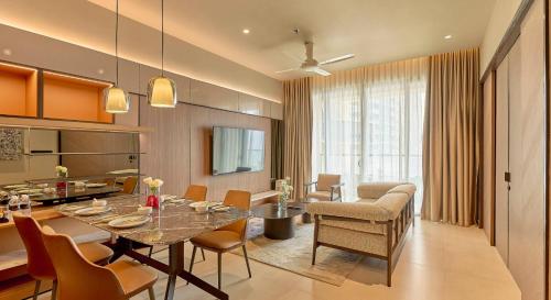 une salle à manger et un salon avec une table et des chaises dans l'établissement Premium Antara Genting Highlands by COBNB - near Link Bridge, à Genting Highlands