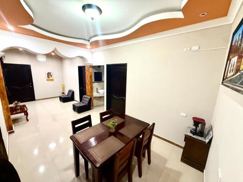 a dining room and living room with a table and chairs at Apartamento Hotel Alfa y Omega in San Benito
