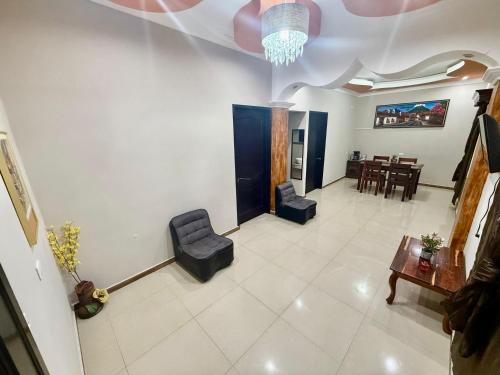 a living room with two chairs and a table at Apartamento Hotel Alfa y Omega in San Benito