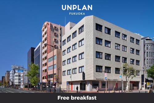 a building on the corner of a city street at UNPLAN Fukuoka in Fukuoka
