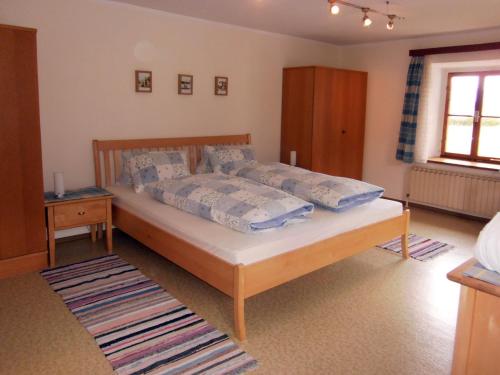 a bedroom with a large bed in a room at Pilznerhof in Strobl