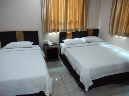 Ένα ή περισσότερα κρεβάτια σε δωμάτιο στο Hotel Traveller