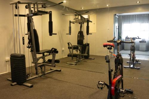 a gym with several tread machines and a bike at Avioré Hotel Tacloban in Tacloban