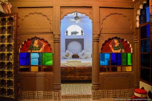 a room with a bed and two stained glass windows at Castle View Haveli in Jodhpur