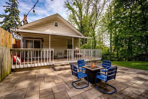 a patio with chairs and a table and a house at Cozy Cottage in the Heart of Hyde Park home in Cincinnati