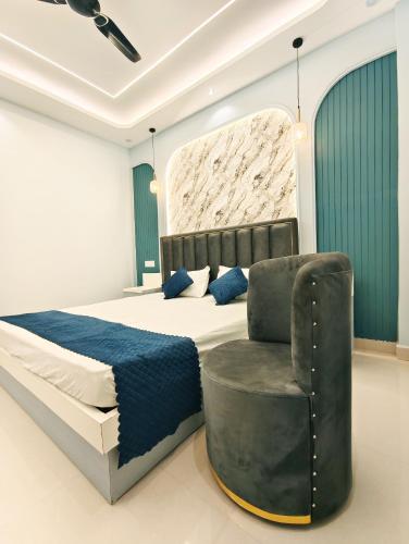 a bedroom with a bed and a chair at Luvkush Inn A Premium Homestay in Ayodhya