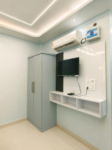 a room with a tv and a cabinet with a television at Luvkush Inn A Premium Homestay in Ayodhya