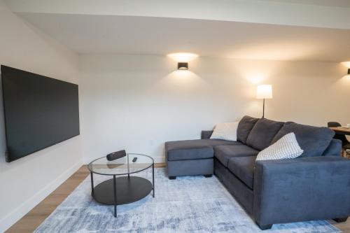 a living room with a couch and a flat screen tv at Peaceful Suite near Vernon Armstrong Brand New in Armstrong