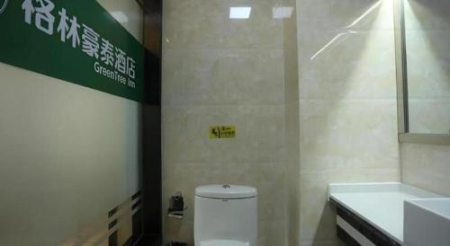 a bathroom with a toilet and a sink at GreenTree Inn Anqing Yingbin Dong Road High-Speed Railway Station in Anqing