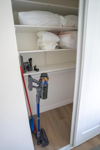 a room with a vacuum cleaner in a closet at Peaceful Suite near Vernon Armstrong Brand New in Armstrong