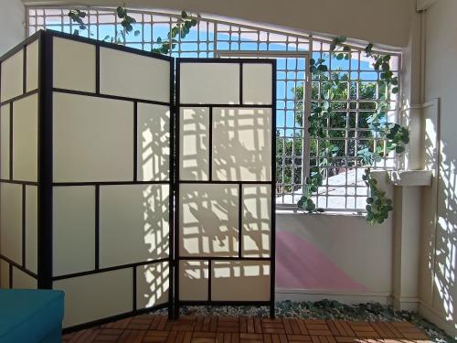 a glass door in a room with a window at Tere Home 29 Subang by Manhattan Group in Shah Alam