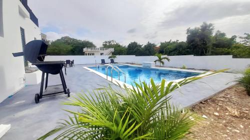a patio with a chair and a swimming pool at Blanco Oasis in Banks