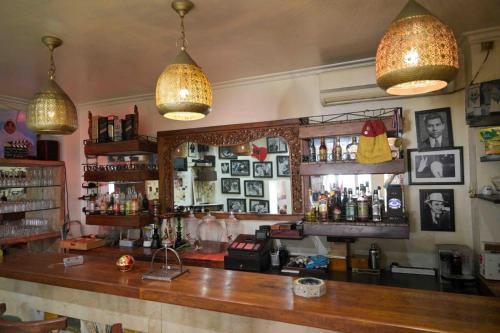 a bar in a pub with pictures on the wall at Hotel Brajas in Antananarivo