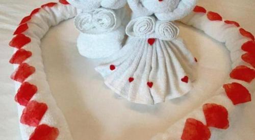 a cake shaped like a teddy bear with hearts on it at Vienna Hotel Guangxi Fangcheng in Fangcheng