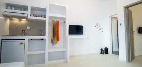 a kitchen with a sink and a counter top at Naxos Colosseo in Agios Prokopios