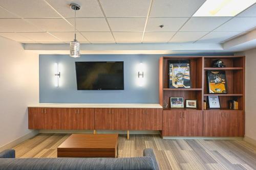 a waiting room with a flat screen tv on a wall at Holiday Inn Express Houghton-Keweenaw by IHG in Houghton