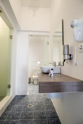 a bathroom with a sink and a mirror at Naxos Colosseo in Agios Prokopios