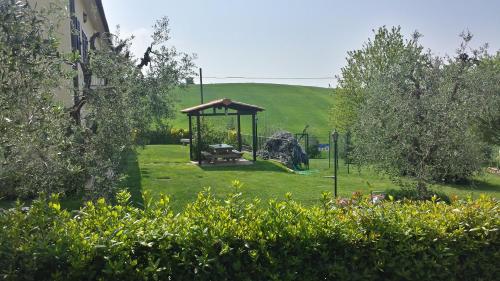 a garden with a gazebo and a playground at Le Ville in Lorenzana