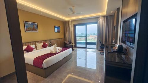 a hotel room with a bed and a television at Pride Resort Jodhpur in Banār