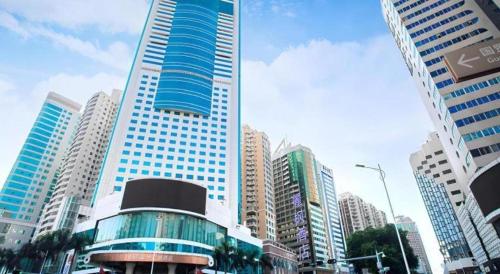 a tall building in a city with tall buildings at Lavande Hotel Shenzhen East Gate Wanxiang City Guomao Metro Statipn in Shenzhen