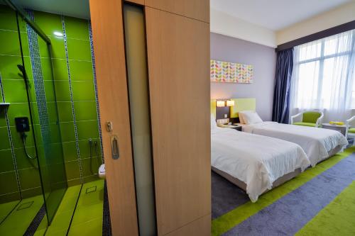 a hotel room with a bed and a bathroom at Mega View Hotel in Kuantan