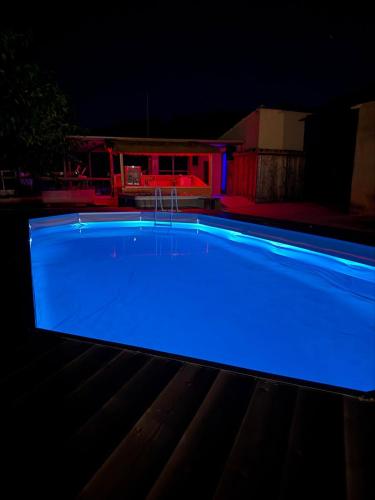 a swimming pool lit up blue at night at Za Teresa - Napoleonic Private Resort & Spa - Entire property only in Giuliano Teatino