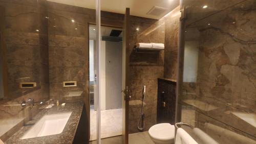 a bathroom with a sink and a toilet and a shower at Pride Resort Jodhpur in Banār