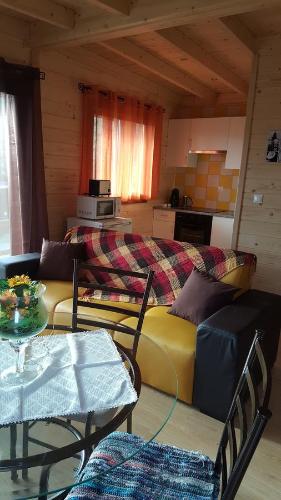 a living room with a couch and a table at Zona Balnear do Meimao in Meimão