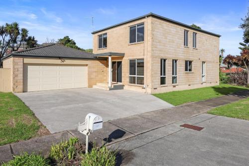 a house with a garage in front of it at 4 BR house near beach sleeps 9 in Warrnambool