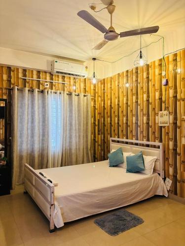 a bedroom with a large bed in front of a window at The Hushe in Guwahati