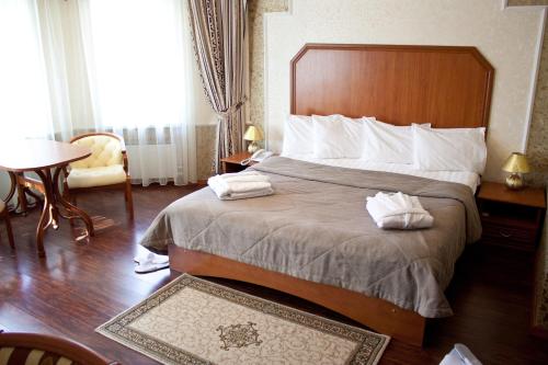 a hotel room with a bed with two towels on it at Europa Hotel in Noyabrsk