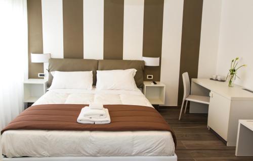 a bedroom with a large bed and a desk at Sea Room Sorrento in Sorrento