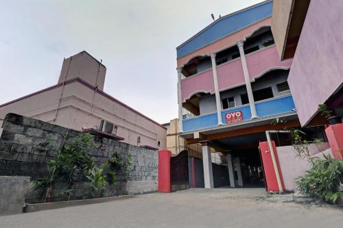 a group of buildings sitting next to each other at Super Collection O Velachery Railway Junction Formerly Vijay Guest House in Chennai