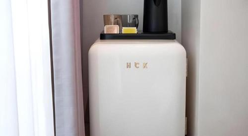 a white refrigerator sitting next to a window at Harbour Bay Hotel in Hong Kong