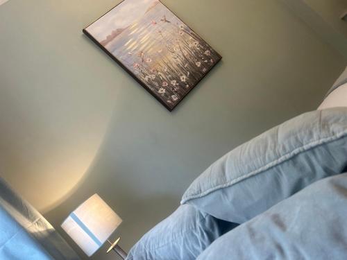 a bedroom with a picture on the wall next to a bed at Corbridge Apartment in Corbridge