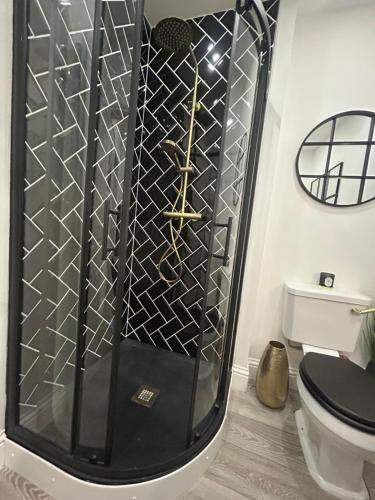 a shower in a bathroom with a toilet at Corbridge Apartment in Corbridge