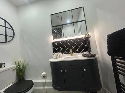 a bathroom with a sink and a mirror at Corbridge Apartment in Corbridge