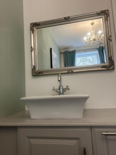 a bathroom sink with a mirror above it at Corbridge Apartment in Corbridge