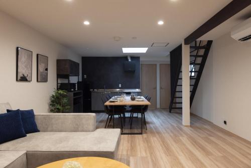 a living room with a couch and a table at Soyogi Stay in Takayama