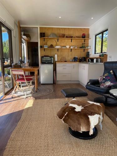 a living room with a cow on the floor at Puhoi Studio in Puhoi