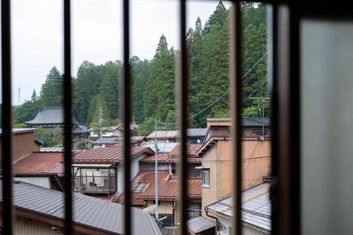 a view of a city from a window at Soyogi Stay in Takayama