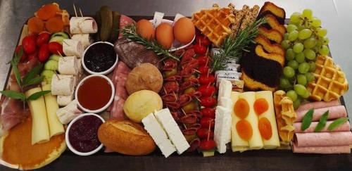 a tray of food with different types of food at Villa PARADISE in Néa Michanióna