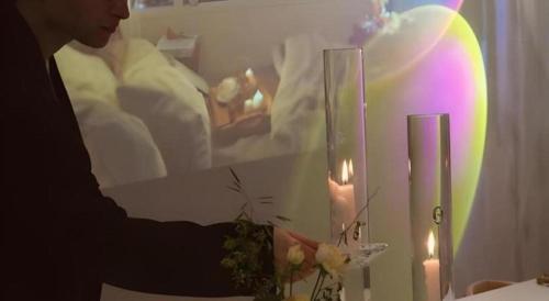 a woman holding a vase with flowers in a room at CS Premier Hotel in Seoul